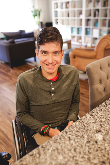 young man in wheelchair at home about to transition from pediatric to adult care